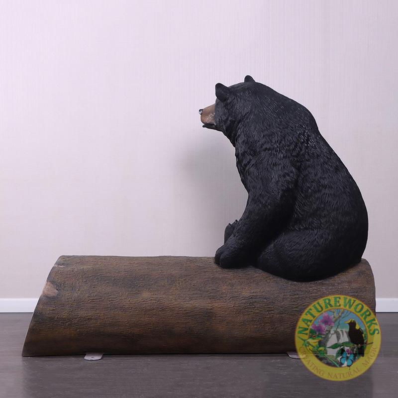 Natureworks Australia Bear sitting on tree trunk - bench seat - looking left