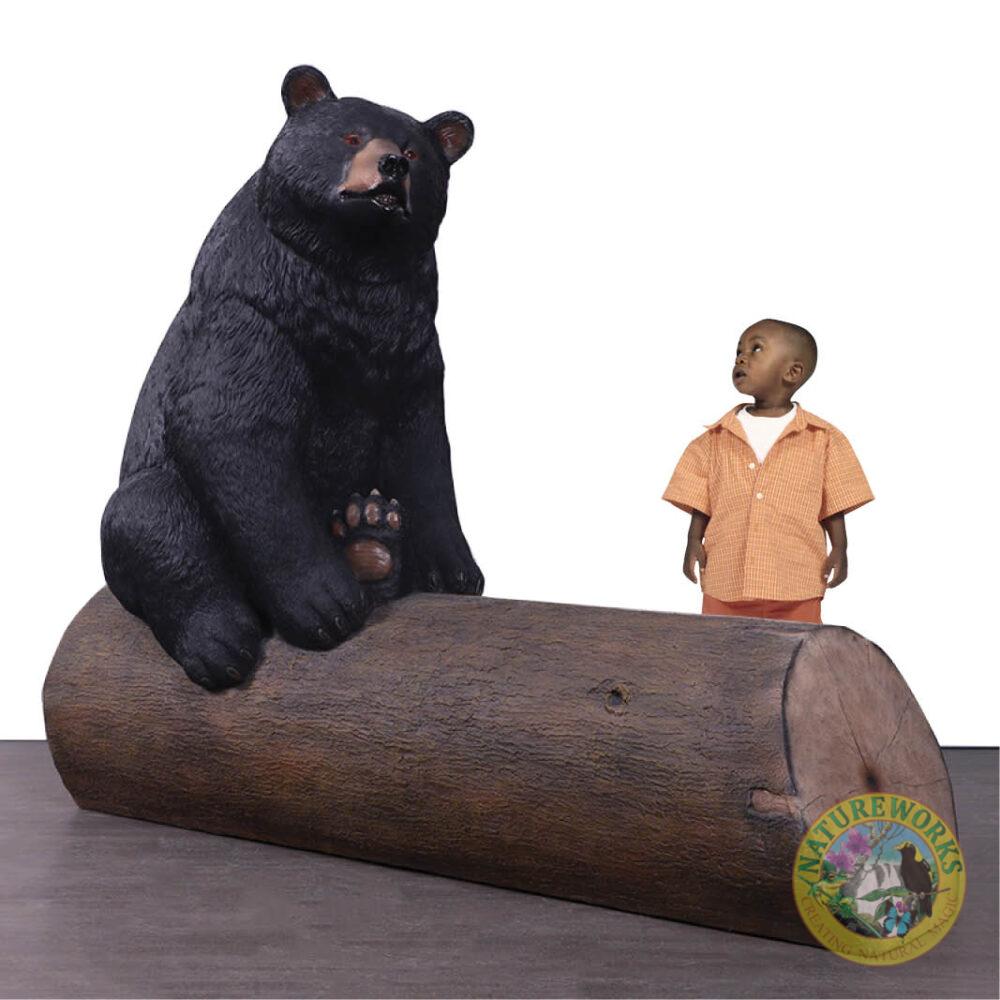 Natureworks Australia Bear sitting on tree trunk - bench seat - shown with boy - 240130