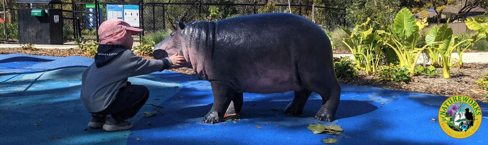 Natureworks Australia Safari-themed playground with hippo sculpture and child