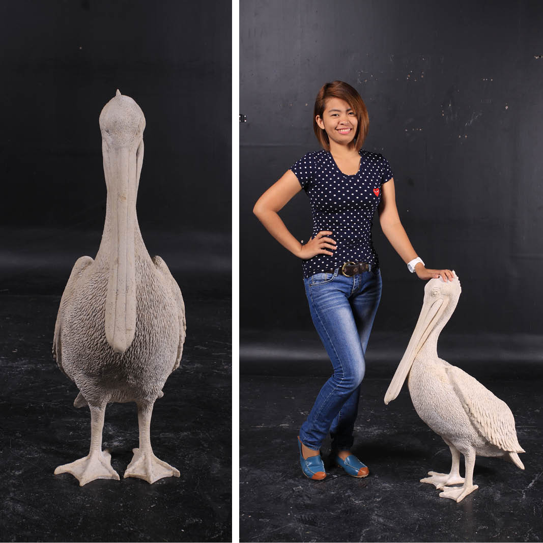 Natureworks Australia Pelican standing - 090073RS - roman stone finish - shown with lady for size comparison
