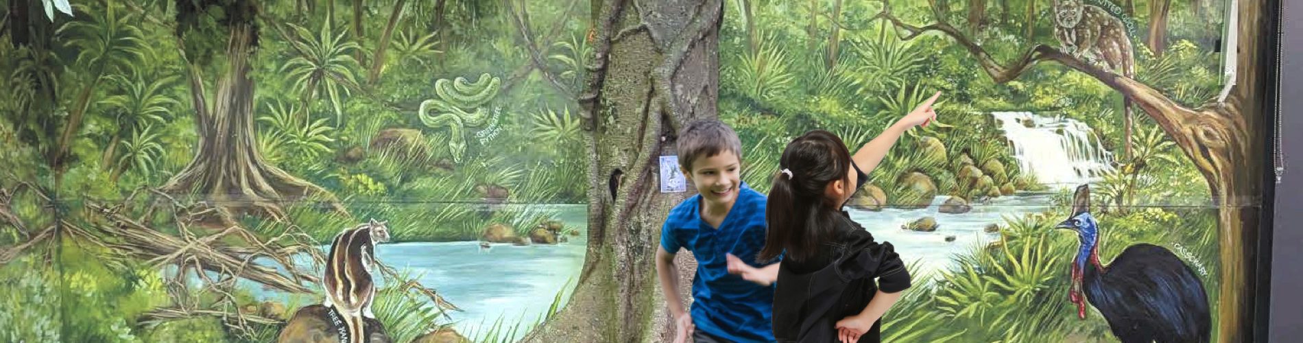 Children in front of Artificial fig tree and mural at William timson school