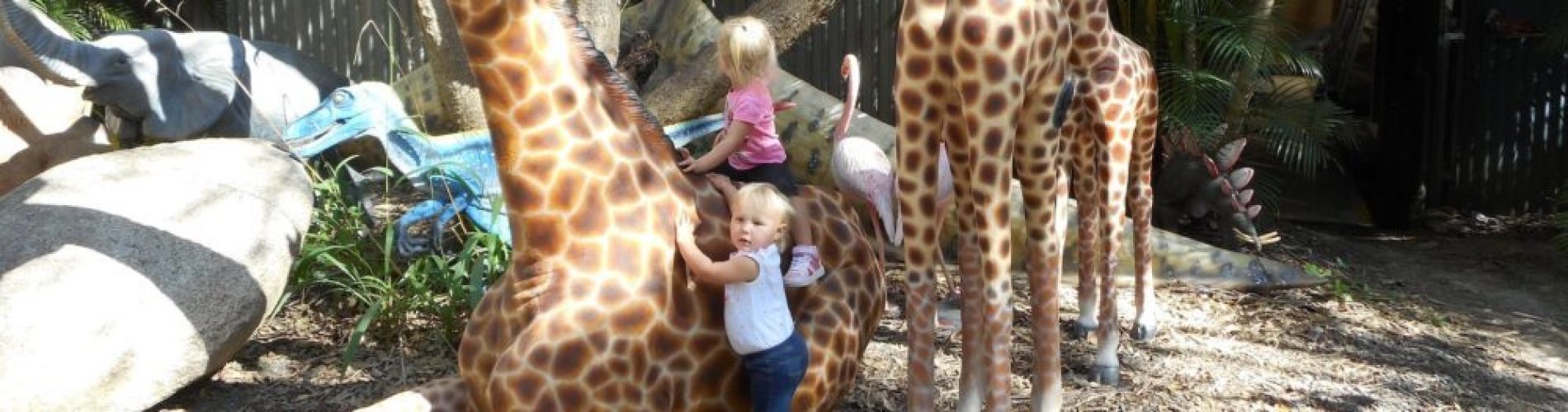 Children playing with animal sculptures